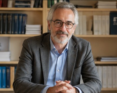 Professor seated in a study lined with books, representing expertise and AI education